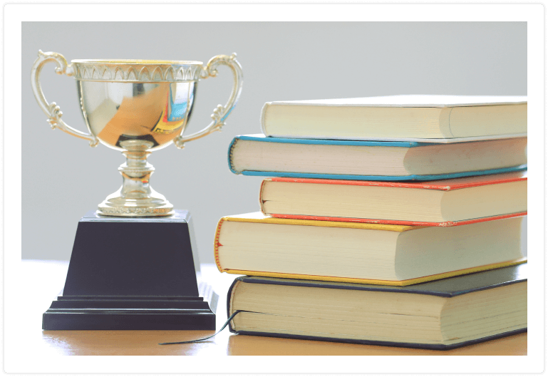 books-with-trophy