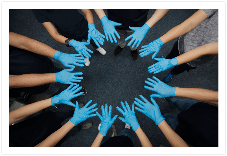 blue gloved hands making a circle